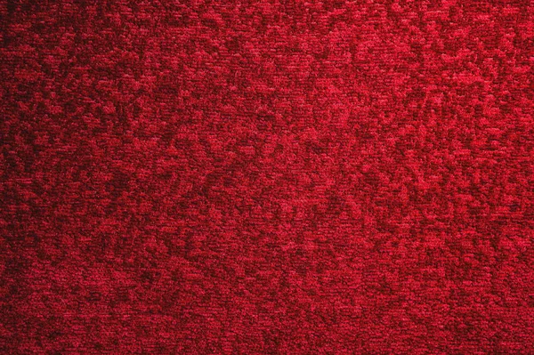Textur eines dunkelroten Teppichs. Nahaufnahme von Gradientenlicht — Stockfoto