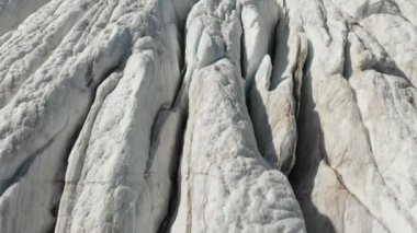 Yakın çekim düşük uçuş 4 k dağlık sürünen buzulun derin çatlaklar üzerinden. Buzul sarı volkanik kum ile toz