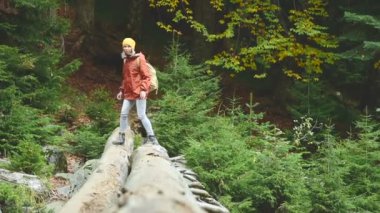 İnce kız ormanda bir dağ nehir aracılığıyla oturum boyunca yürüyüş. Turizm Caucasus yedekte. Kameranın doğru gider