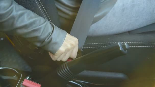 Close-up of action girl fastens a seat belt in a car before dropping off. Safe driving concept — Stock Video