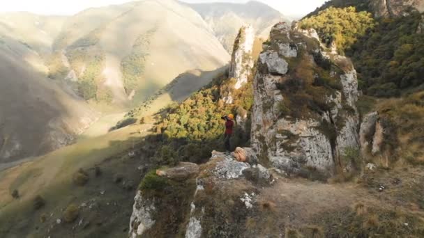 Fotografin Blondine mit Hut geht mit Kamera in den Bergen. chegem Schlucht Nordkaukasus — Stockvideo