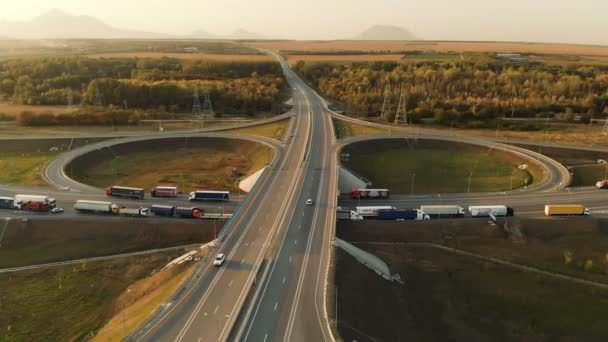 Luftaufnahme. Autobahn und Überführung mit Autos und Lastwagen. Die Straßenkreuzung ist eine zweistufige Straßenkreuzung außerhalb der Stadt. Blick von oben — Stockvideo