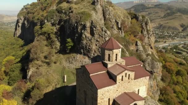 4K UHD Aerial view of a mountain monastery standing on a cliff. Ancient Christian temple of the 10th century located in Karachay-Cherkessia. Russia. North Caucasus — Stock Video