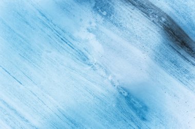 Close-up wall of a centuries-old glacier with a structure of stripes and bubbles. Ice blue light texture. clipart