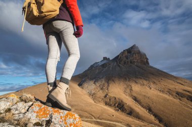 Yakın bir kız gezgin arka arka planda epik çekim açık kayalar. Portre belden