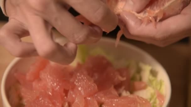 El primer plano de las manos de una chica en la cocina de casa limpia y corta pomelo para una ensalada vegetariana. Cocina casera saludable — Vídeos de Stock