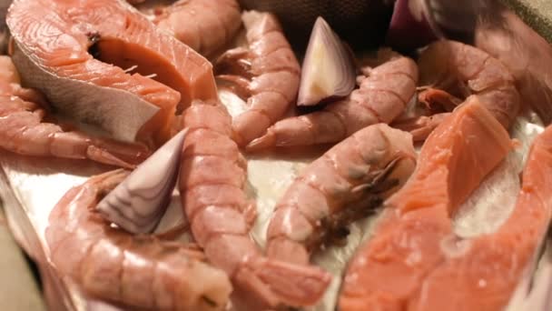 Close-up seafood on protvine. Raw salmon with prawns and onions raw to roast. Shallow depth of field. top view — Stock Video