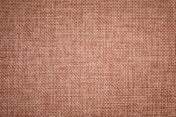 Texturerat bakgrund ytan av textil klädsel möbler närbild. säckväv brun färg tyg struktur — Stockfoto