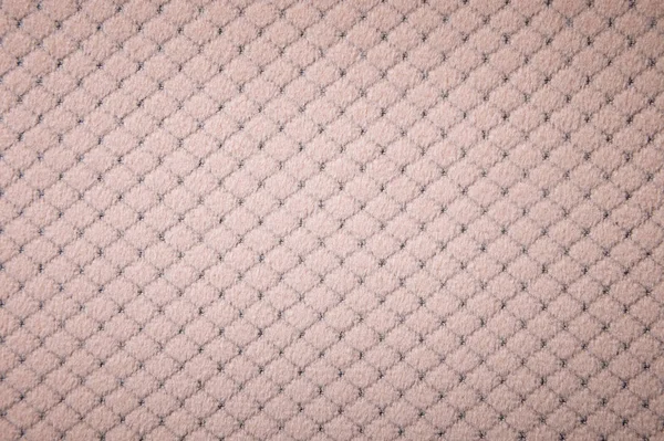 Текстурированная задняя поверхность мягкой мебели крупным планом. мешковатая бежевая ткань — стоковое фото