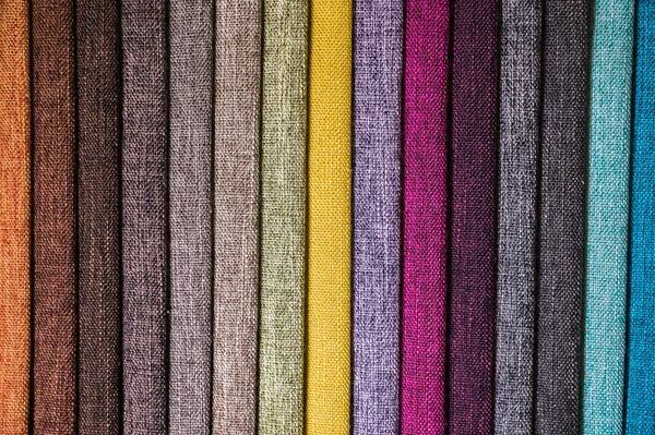 Colorful and bright fabric samples of furniture and clothing upholstery. Close-up of a palette of textile abstract stripes of different colors Royalty Free Stock Images