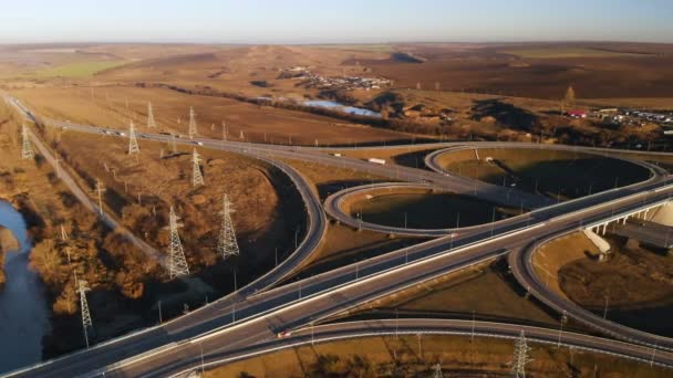 Aerial view. Highway and overpass with cars and trucks. The road junction is a two-tier road junction outside the city. View from above — Stock Video