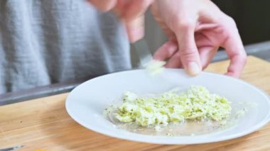 Bir çatal ile eller Close-Up tereyağı baharatlar ile karıştırılır. Ev mutfak. Sos için