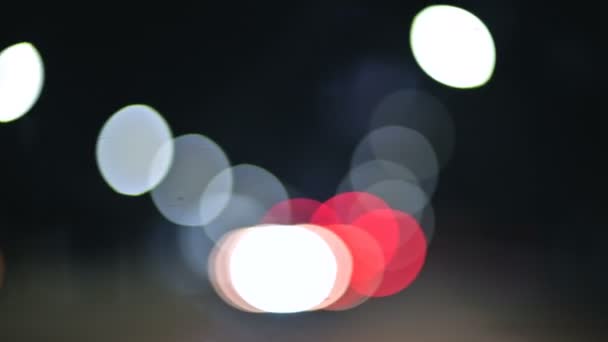 Colored bokeh lights in the night country road. moving circles of traffic highway lights. Defocused night road — Stock Video