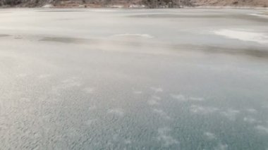 Hava görünümü. Kuzey Kafkasya'da dağ gölü dondu. Kamera çalışmıyor. Alacakaranlık dağlarda
