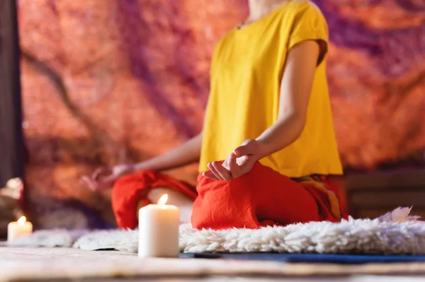 stock image Close-up of womans hand in yoga lotus pose meditating in a crafting room with candles