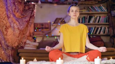 Gevşek giysiler içinde ciddi bir güzel genç kız mumlar ile çevrili bir Lotus pozisyonda beyaz bir kürk cilt üzerinde bir zanaat odasında oturur. Meditasyon ruhsal büyüme ve bakım kendi sağlık için