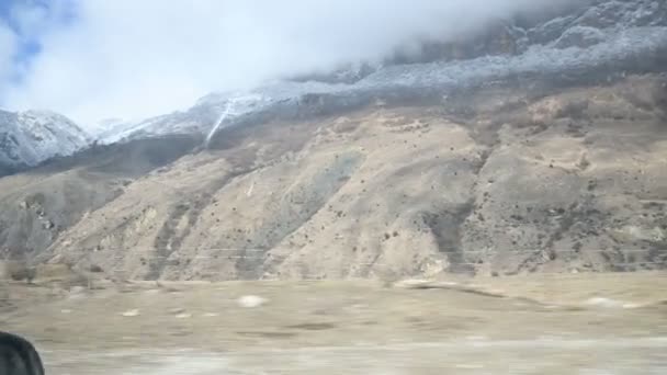 A view from the side window of the car in front of the seated passenger to the beautiful views of the Caucasus mountains sweeping past. Travel adventure video by car in the mountains — Stock Video