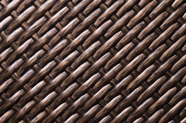 Close-up Koyu kahverengi arka plan polimer liflerden yapılmış hasır mobilya bir unsurdur. Sentetik lüks substrat