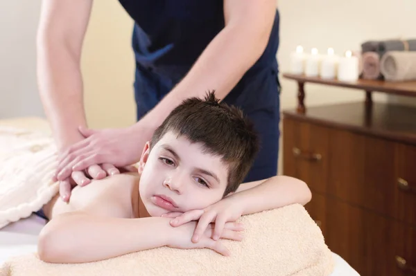 Relaxed little boy on reception at the chiropractor. Wellness massage procedure — Stock Photo, Image