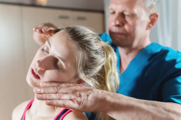 Masajista manual visceral masculino trata a una paciente joven. Edición de cuello y vértebras — Foto de Stock