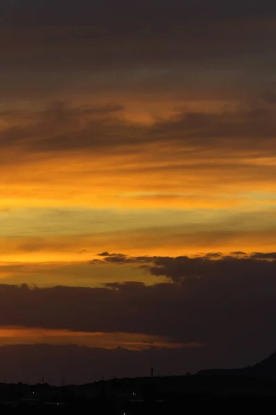 Fondo abstracto de la naturaleza. Cielo espectacular puesta de sol en las nubes saturadas de colores brillantes de naranja y amarillo. Contraste de llave baja —  Fotos de Stock