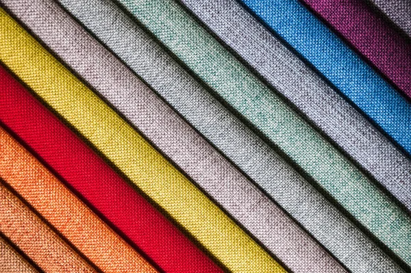 Colorful and bright fabric samples of furniture and clothing upholstery. Close-up of a palette of textile abstract diagonal stripes of different colors — Stock Photo, Image
