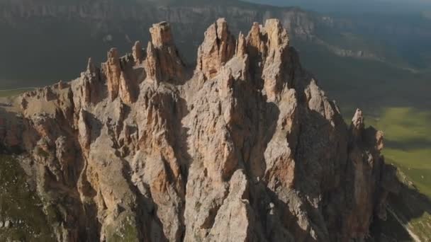 Professional aerial view of a rocky mountain in the evening at sunset. Sharp Cliffs Extreme Climbing Concept — Stock Video