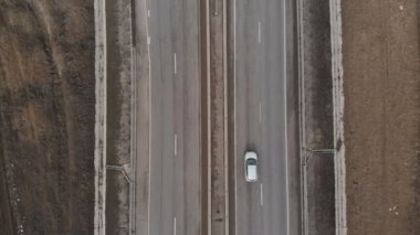 Sonbaharda ya da kışın karsız bir banliyö nakliye yolunun havadan görünüşü. Otobanda arabalar sürüyor..