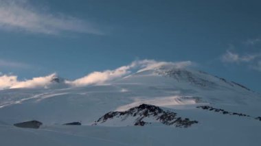 Zaman eğrisi, günbatımından önce rüzgarlı ve karlı bulutların güney ladin hareketidir. Kar ile yüksek irtifa zaman ayarlı. Dağlarda hava değişiyor.