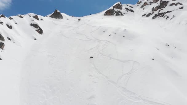 Luchtfoto atleet skiër freerider staat aan de top van de zijlijn hoog in de bergen voor te bereiden om naar beneden te dalen. Skitour en freeride op de onvoorbereide hellingen van de noordelijke Kaukasus — Stockvideo