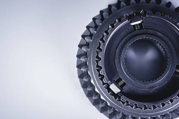 Närbild av ett kugghjul i en växellåda på en grå bakgrund. Mekaniskt begrepp — Stockfoto