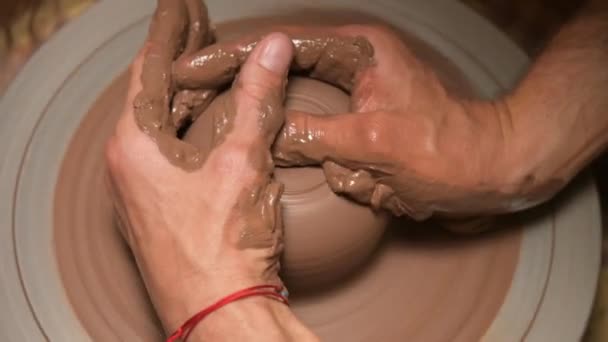 A close-up of a potters hand creates a clay bowl on a potters wheel. Handmade clay tea accessories — Stock Video