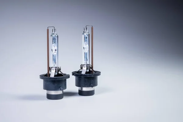 Two New xenon lamp on a gray gradient background. The concept of discharge lamps to replace conventional incandescent lamps — Stock Photo, Image