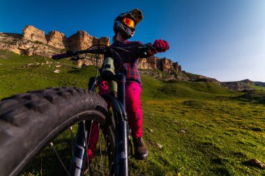 Geniş açıdan genç sporcuların dikey fotoğrafı. Dağ bisikleti süren profesyonel bir binici. geniş açı