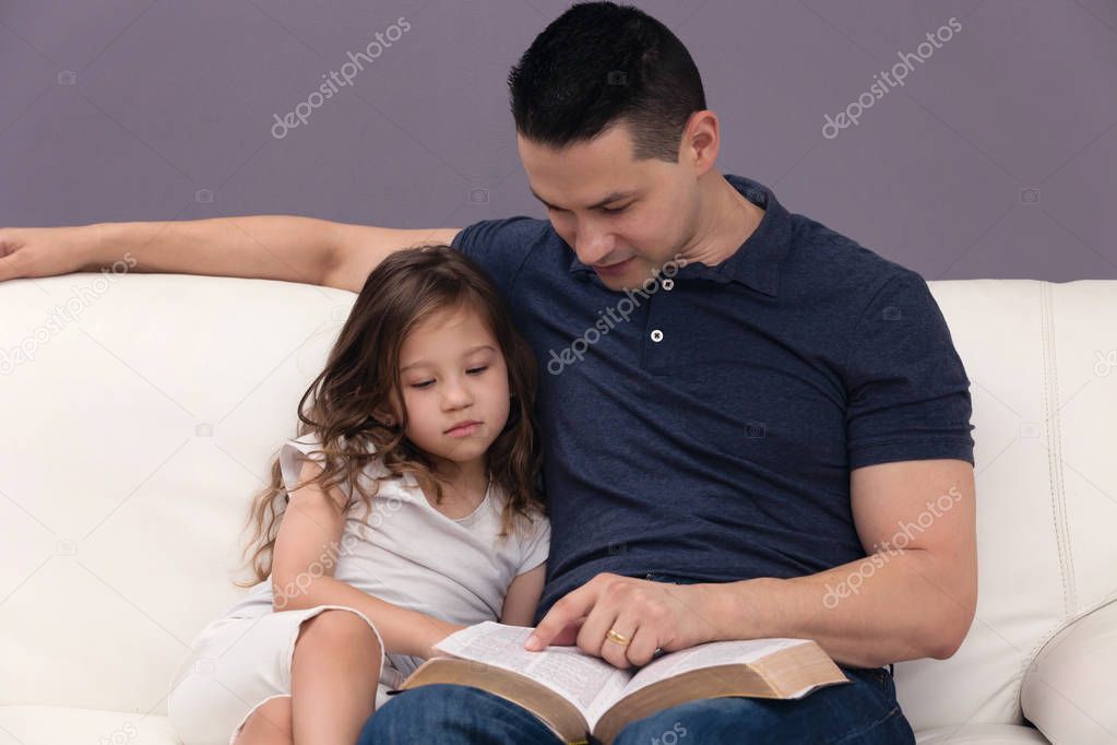 Daddy Reading His Little Girl the Word of God 