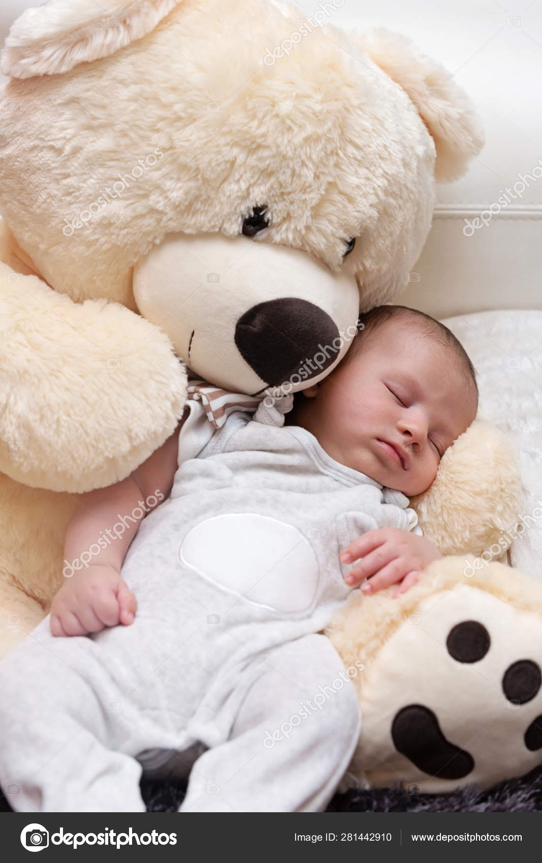 baby sleeping with teddy