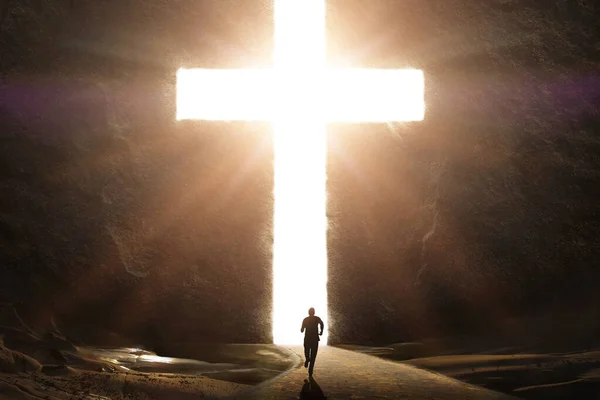 輝く光線で巨大な明るい十字架に向かって走っている男 ロイヤリティフリーのストック画像