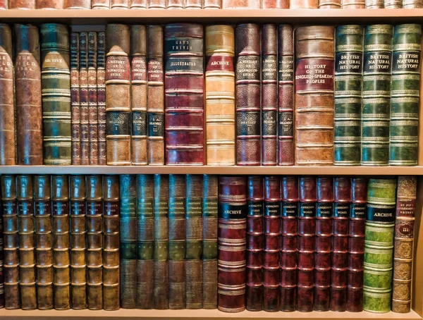 Vintage books on bookshelf with light on top Stock Photo