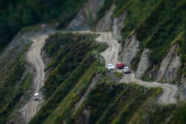 Cars move on dangerous Katu Yaryk mountain pass. Altai, Russia clipart