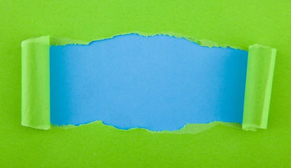 Torn Green Paper Isolated Blue Background — Stock Photo, Image
