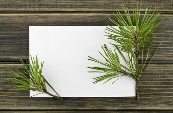 Papel Blanco Rama Árbol Navidad Sobre Fondo Madera —  Fotos de Stock