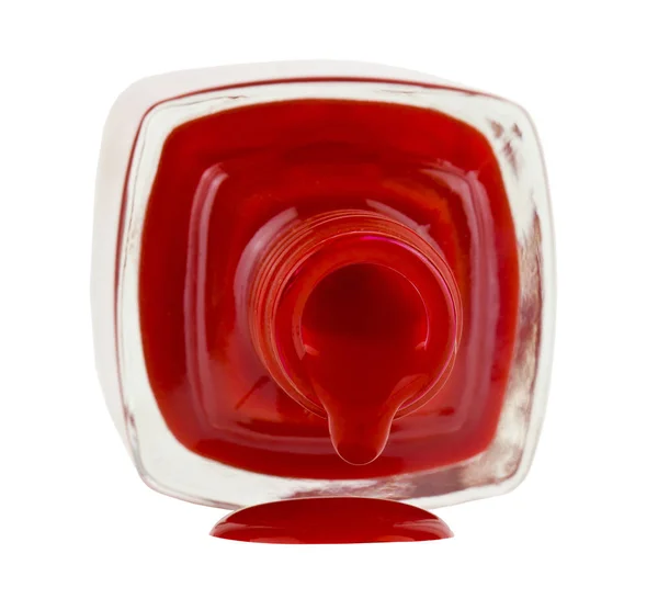 Flaska med rött nagellack isolerade på vit bakgrund nära u — Stockfoto