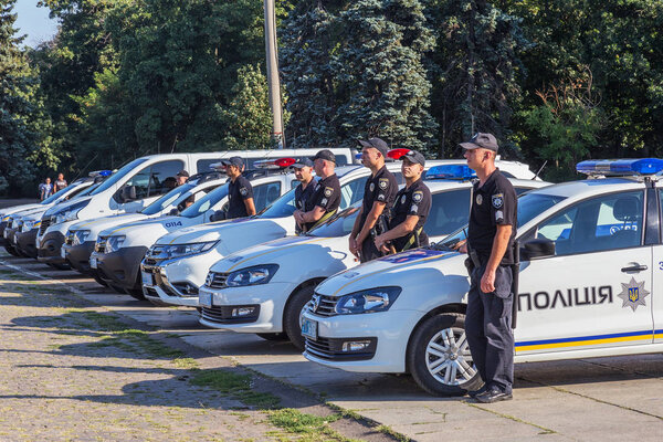 Odessa, Ukraine - August 01, 2018: Convoy of specialized police cars with police officers is assigned task, combat order before patrolling streets of city. Police specialized cars on parade ground