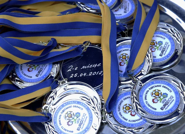 ODESSA, UKRAINE - April 25, 2012: Latex medals and cups winners of the championship at the stadium during a game of football club Chernomorets, April 24, 2012, Odessa, Ukraine