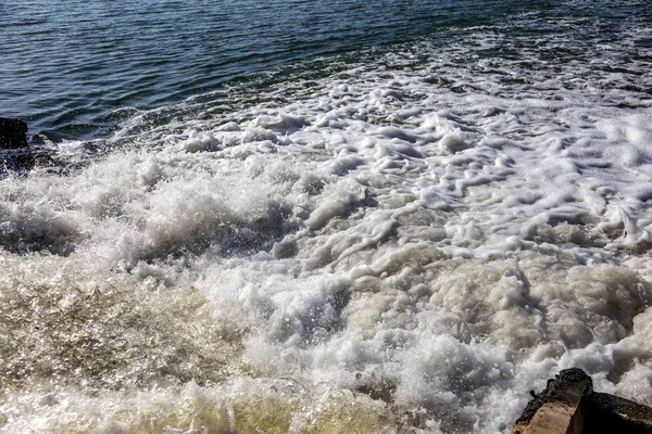 Dirty waste water from the municipal sewer openly merge into the marine estuary. Wastewater treatment plants. The environmental problem of environmental pollution.