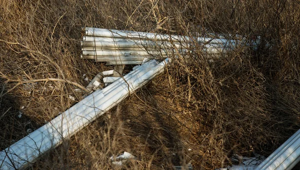 Ecological problem, disaster. Criminal disposal of fluorescent mercury lamps, E-waste. Environmental pollution. Ecological crime. Dirty broken fluorescent lamps, old fluorescent lamp dangerous rubbish