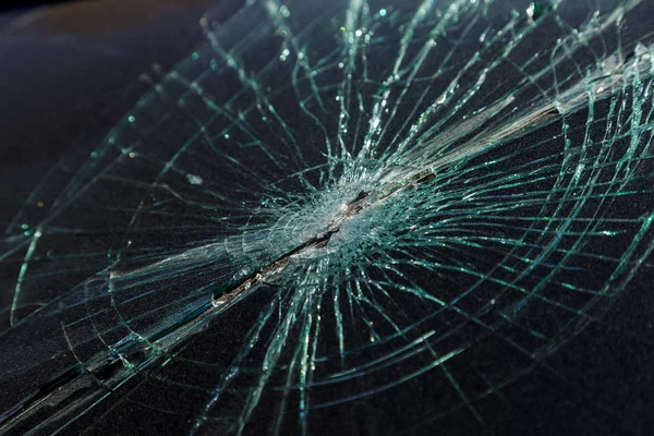 Terrible dangerous car after a fatal accident. Broken windshield. A broken car with broken glass. Car hazard. Reckless dangerous driving. Broken windshield after fatal accident with a pedestrian