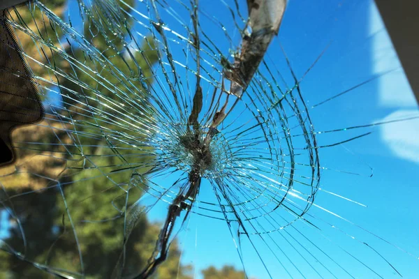 Terrible dangerous car after a fatal accident. Broken windshield. A broken car with broken glass. Car hazard. Reckless dangerous driving. Broken windshield after fatal accident with a pedestrian