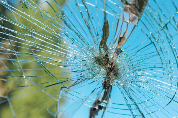 Terrible dangerous car after a fatal accident. Broken windshield. A broken car with broken glass. Car hazard. Reckless dangerous driving. Broken windshield after fatal accident with a pedestrian