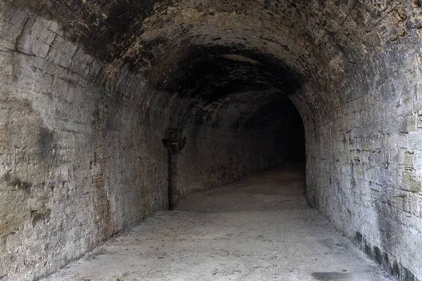 Old abandoned tunnel in the underground wine cellar. Entrance to the catacombs in Odessa, Ukraine. As a creative background for staged dark design